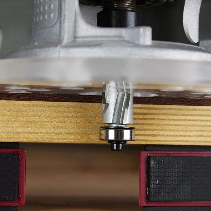 Close-up of spiral router bit cutting wood on router table, woodworking tool in use