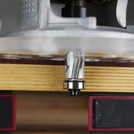 Close-up of spiral router bit cutting wood on router table, woodworking tool in use