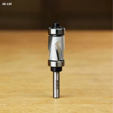 Carbide spiral flush trim router bit with dual bearings on a wood surface