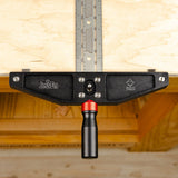 Woodworking clamp with JessEm logo attached to a workbench and metal measuring guide