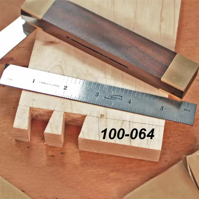 Dovetail joint woodworking with steel ruler and marking gauge on wood board