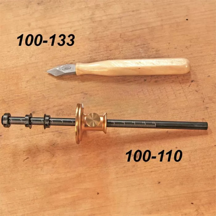 Marking knife and woodworking marking gauge on wooden surface with product numbers shown.
