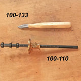 Woodworking marking knife and marking gauge on wood surface, labeled 100-133 and 100-110.