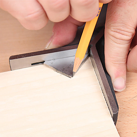 Marking wood with a pencil and a precision woodworking square tool on a workbench