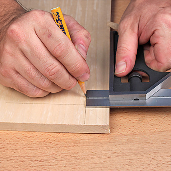 Marking a straight line on wood with a pencil and combination square for woodworking