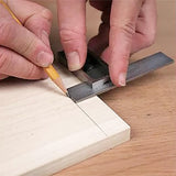 Marking a straight line on wood with a combination square and pencil for woodworking