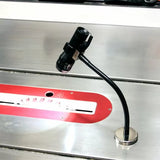 Magnetic LED work light attached to a table saw, illuminating the saw blade area