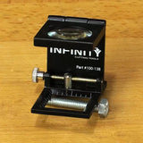 Magnifying edge gauge tool for woodworking on a wood surface, with adjustment screws and ruler markings.