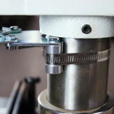 Close-up of a metal woodworking machine part with bracket and hose clamp attached