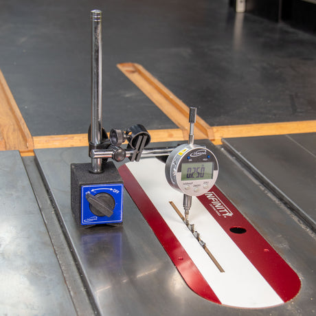 Digital measuring gauge and magnetic base setup to measure a table saw blade height.