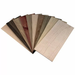 Assorted wood veneer sheets fanned out, showcasing different woodworking materials.