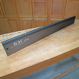 BOW XT546 aluminum router table fence on a wooden workbench in a workshop setting