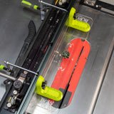 Table saw with green adjustable fence system and red saw blade for precise woodworking cuts