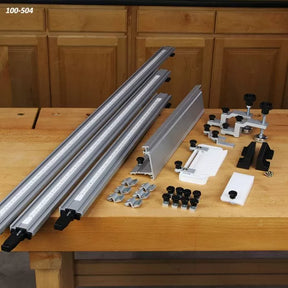 Router table fence system kit with aluminum rails, clamps, and accessories on a workbench
