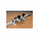 Aluminum router table fence stop with knobs and measuring scale on a wood surface