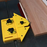 Yellow magnetic woodworking featherboard holding wood on a table saw for precise cutting