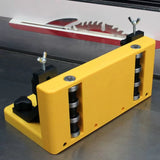Table saw roller guide jig in yellow, mounted on metal saw table for woodworking