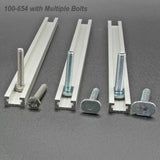 Three T-tracks with assorted bolts for woodworking jigs and fixtures on a gray surface.