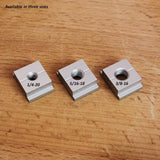 Three T-track nuts in 1/4-20, 5/16-18, 3/8-16 sizes on a wooden surface