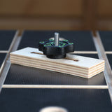 Woodworking T-track hold down clamp with knob on workshop table