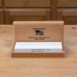 1000 grit sharpening stone in wooden box on workbench, ideal for woodworking tools
