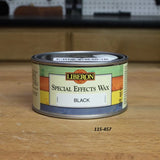 Liberon Special Effects Wax Black 250ml can on a woodworking bench