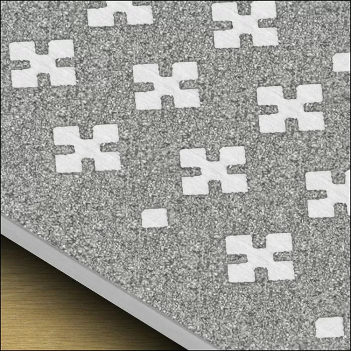 Close-up of textured gray abrasive sandpaper sheet with white cross-shaped perforations