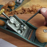 Person adjusting hand plane screws with hex key on woodworking bench