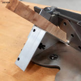 Precision woodworking miter jig holding wood piece on workbench