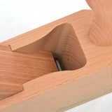 Close-up of a wooden hand plane for woodworking with exposed blade and smooth beech body.
