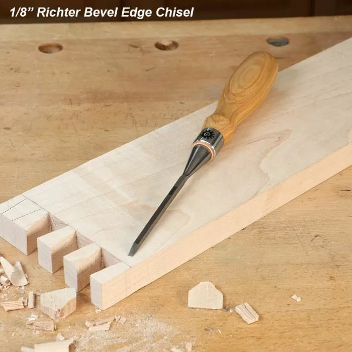 1/8 inch bevel edge chisel with wooden handle on woodworking bench and dovetail joints
