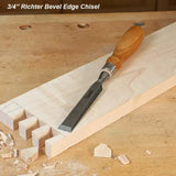 3/4 inch bevel edge chisel with wooden handle on workbench and dovetail wood joint