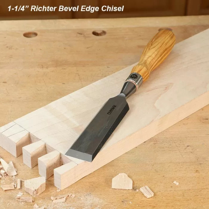 Bevel edge woodworking chisel on a dovetail joint with wood shavings on workbench