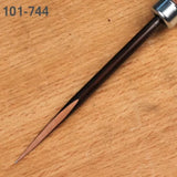 Woodworking marking awl with sharp steel tip and dark handle on wood surface