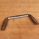 Narex drawknife with wooden handles on a woodworking bench