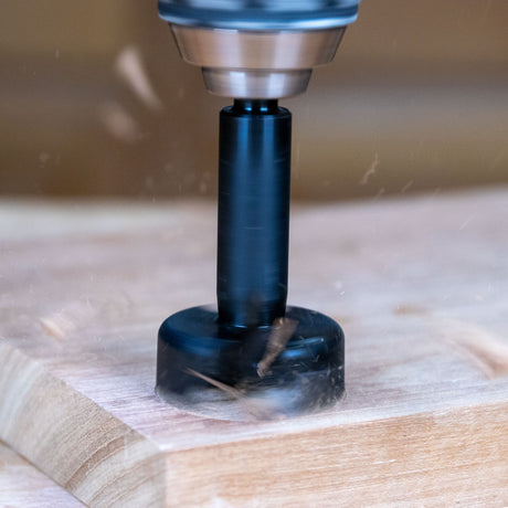 Router bit cutting into wood, showing precise woodworking tool in action