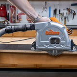 A triton track saw with a dust hose attached with a quick snap adapter.