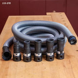 Flexible dust collection hose with five black adapters on a woodworking bench