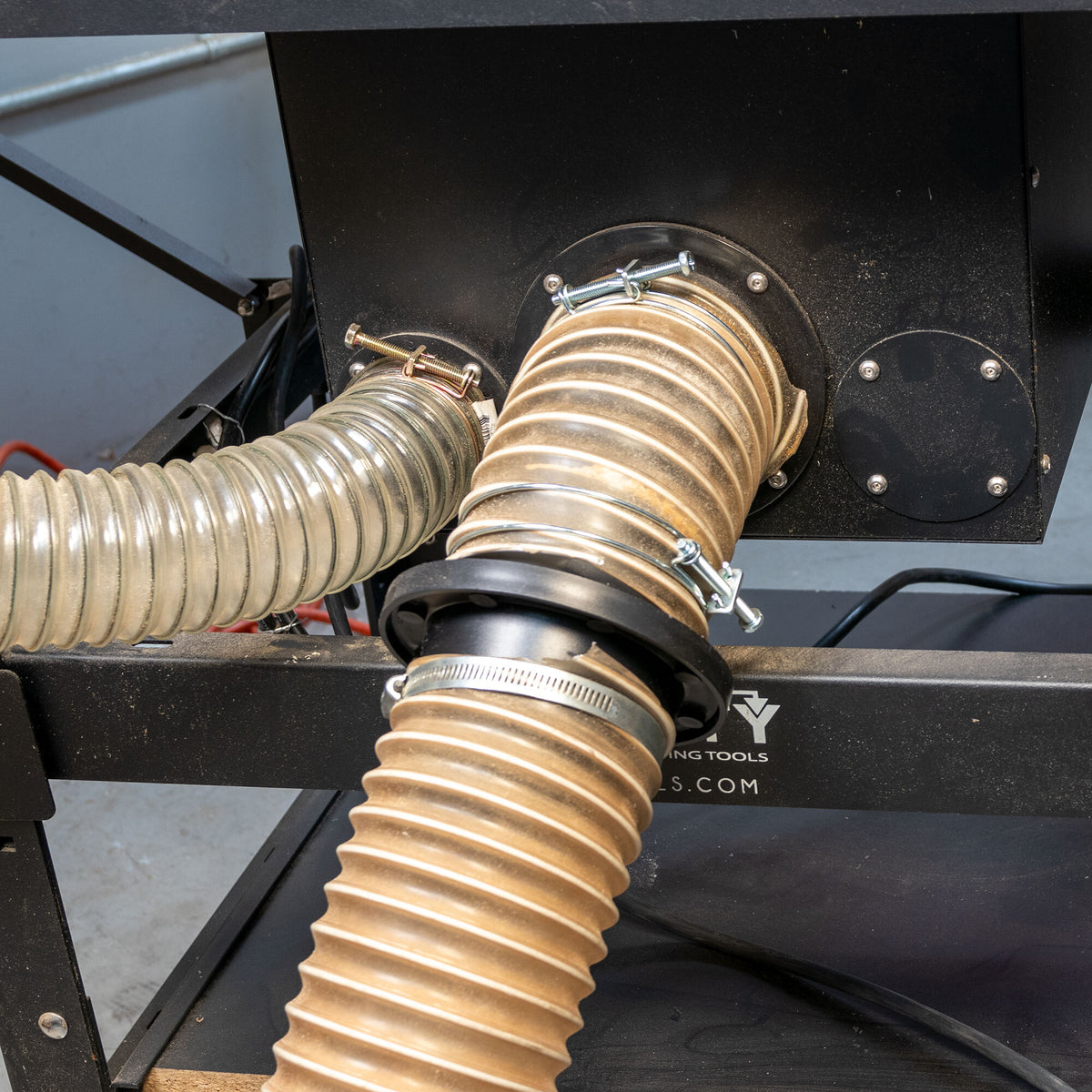 Dust collection hoses connected to a woodworking machine using MagSnap fittings