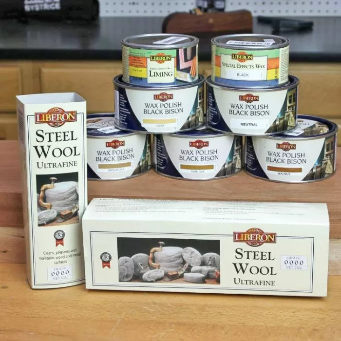 Liberon wax polish Black Bison and steel wool for woodworking surface finishing on workbench