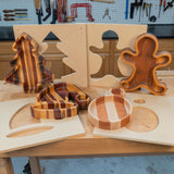 Christmas-themed wooden trays in tree, ornament, stocking, and gingerbread shapes with templates