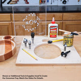 Woodworking tray template kit with router bits, wood glue, oil, and tools on a workshop bench.