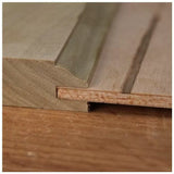 Close-up of tongue and groove wood joint on a flat wooden surface, ideal for woodworking projects.