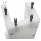 Close-up of woodworking joinery jig with four metal guide pins and white plastic body