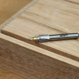 Woodworking router bit on wood surface, precision cutting tool for joinery projects