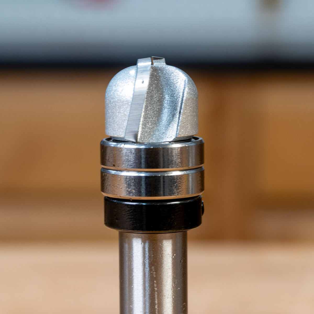 Closeup of a bowl and tray router bit with bearing for woodworking projects
