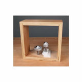 Two carbide-tipped router bits displayed inside a wooden frame on a workbench