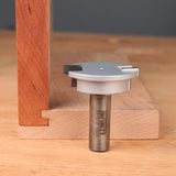 Woodworking slot cutter router bit next to mortise and tenon joint on wooden boards