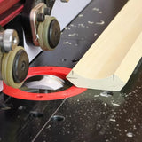 Router table setup with molding bit cutting wood profile, woodworking tool closeup