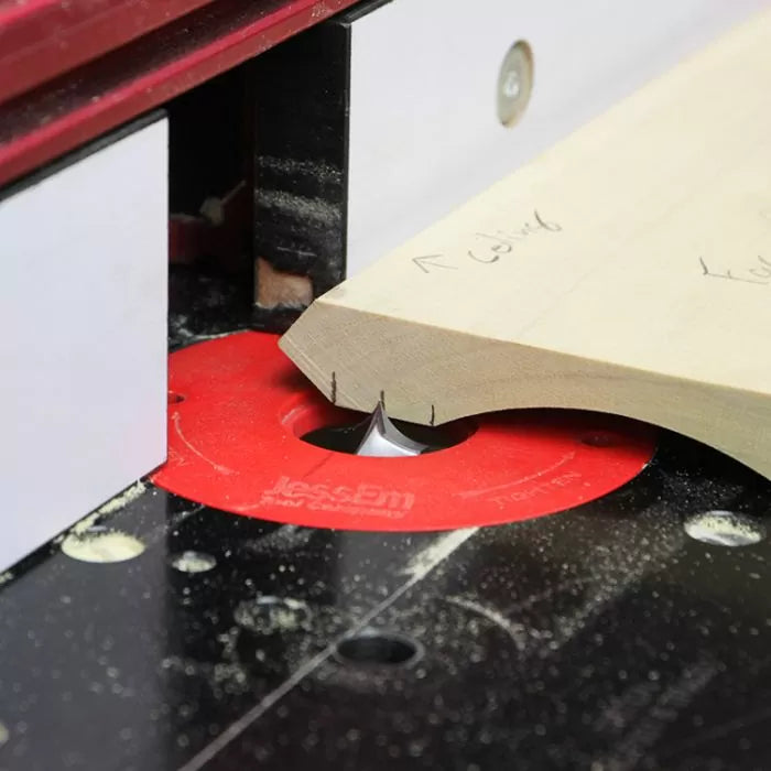 Woodworking router table with router bit shaping wood edge, close-up view